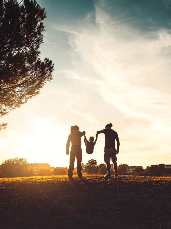 silhouette-of-happy-family-walking-in-the-meadow-a-2022-01-18-23-55-34-utc